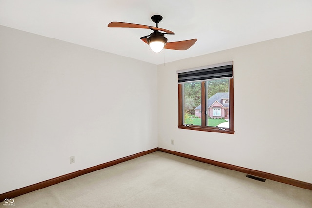 empty room with ceiling fan and carpet