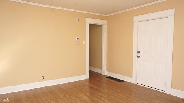 unfurnished room with crown molding and wood-type flooring