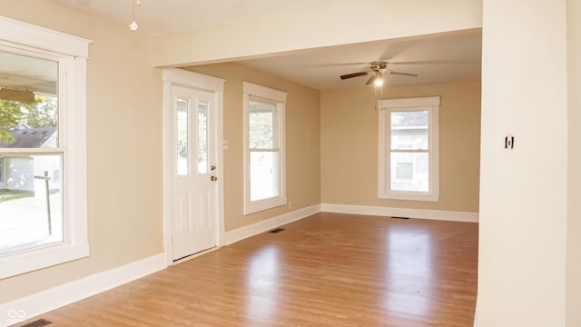 entrance foyer featuring ceiling fan, hardwood / wood-style flooring, and a healthy amount of sunlight