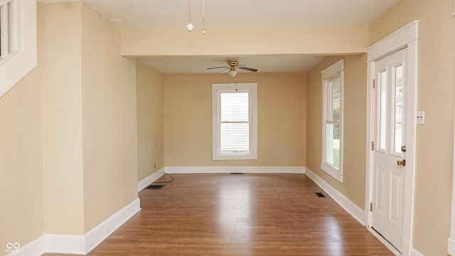 spare room featuring wood-type flooring and ceiling fan