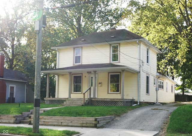 view of front of home featuring covered porch and a front yard