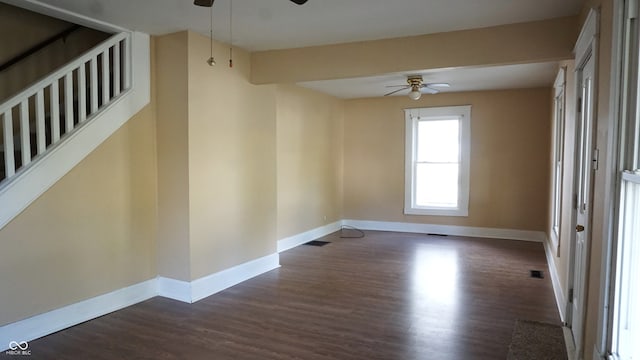 spare room with dark wood-type flooring and ceiling fan