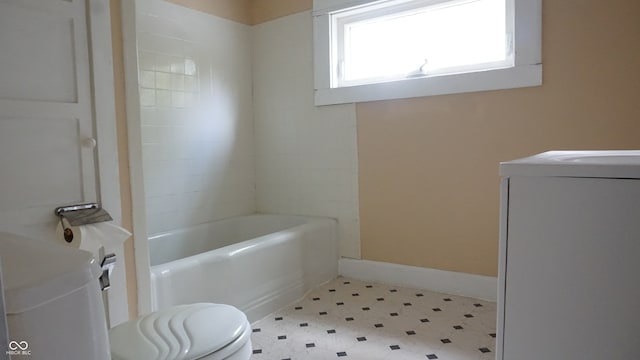 bathroom featuring washer / dryer and toilet