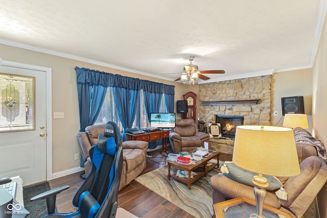 living room featuring crown molding, a fireplace, wood-type flooring, and ceiling fan