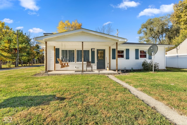 view of front of home with covered porch and a front lawn