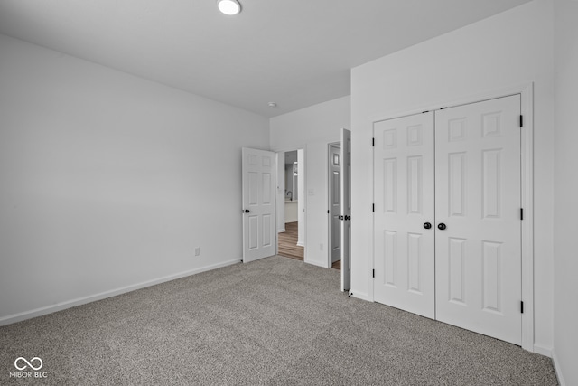 unfurnished bedroom with carpet and a closet