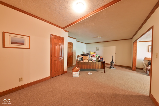 interior space featuring a textured ceiling, carpet floors, and crown molding