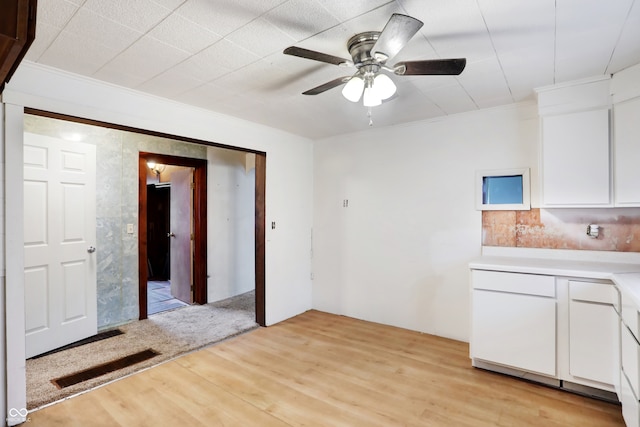 interior space featuring light hardwood / wood-style flooring, white cabinets, ceiling fan, and crown molding