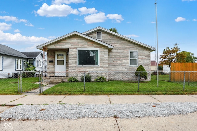 bungalow-style home with a front yard