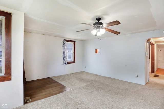 spare room featuring ceiling fan and light colored carpet