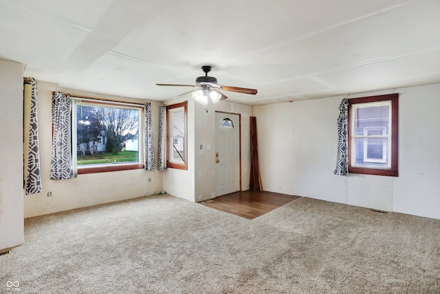 unfurnished room with ceiling fan and carpet flooring