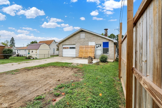 exterior space featuring a garage and a yard