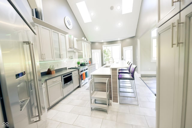 4270 Victoria Ln, Avon, IN 46123 - kitchen with premium appliances, a sink, tasteful backsplash, wall chimney range hood, and a breakfast bar area