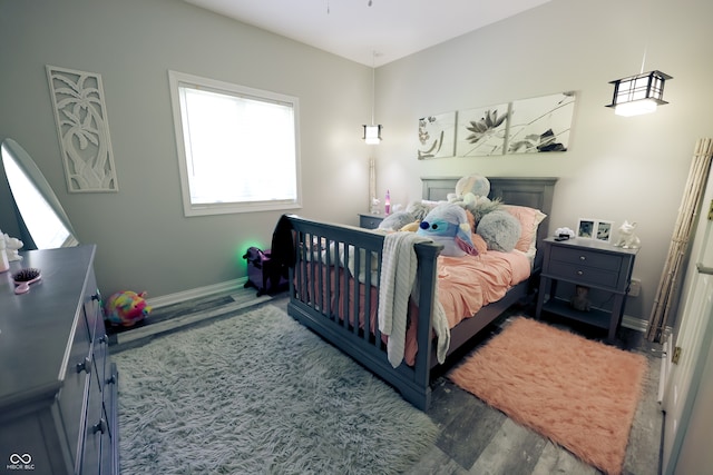 bedroom with dark wood-type flooring