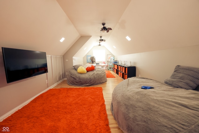 bedroom with vaulted ceiling and hardwood / wood-style flooring