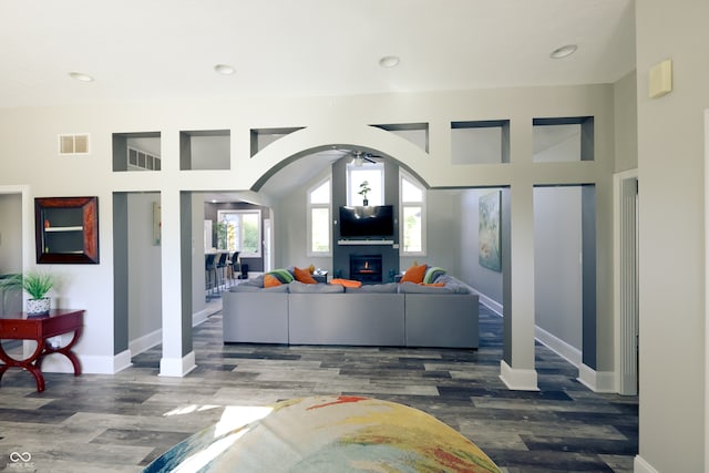 living room with dark wood-type flooring and ceiling fan