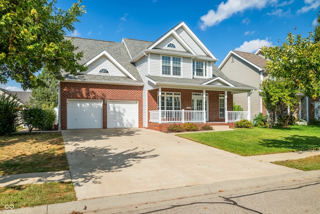 craftsman inspired home featuring a front lawn, a garage, and covered porch