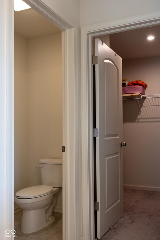 bathroom featuring toilet and tile patterned floors