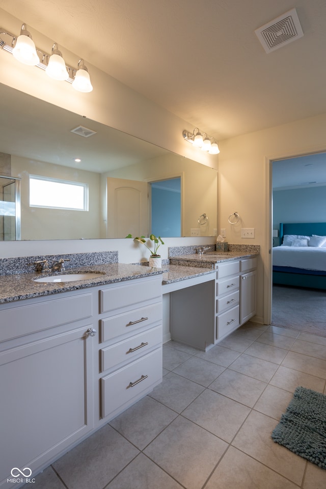 bathroom featuring walk in shower, vanity, and tile patterned floors