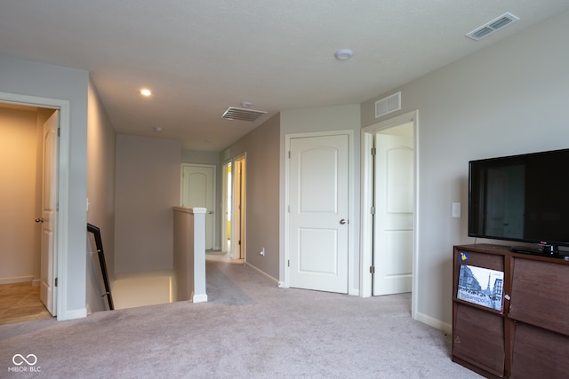 unfurnished bedroom with light carpet