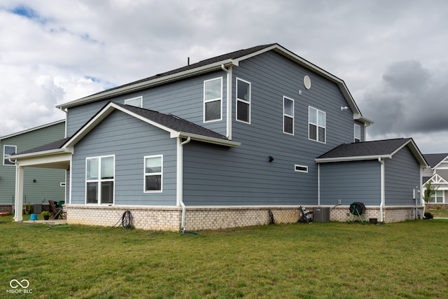 rear view of house with a yard