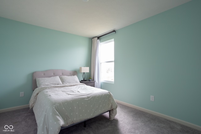 bedroom with dark colored carpet