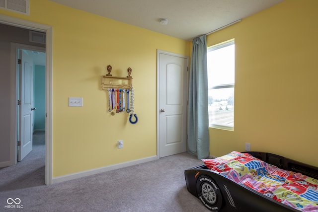 bedroom featuring light carpet