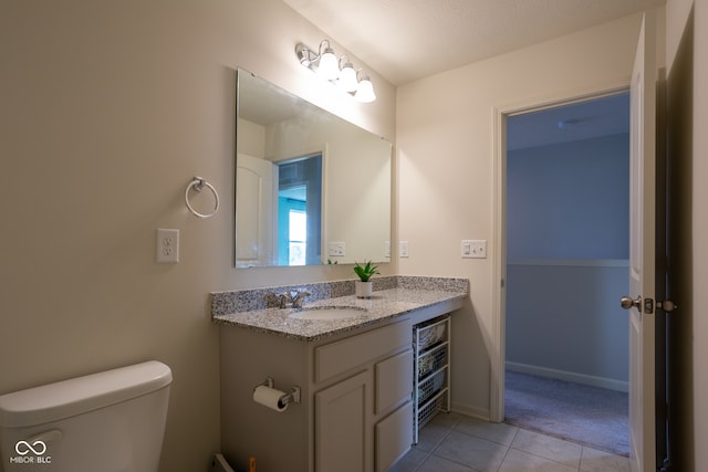 bathroom with a textured ceiling, tile patterned flooring, vanity, and toilet