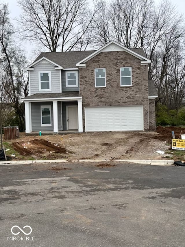 view of property with a garage and central air condition unit