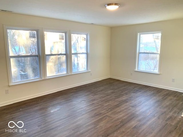 unfurnished room featuring dark hardwood / wood-style flooring