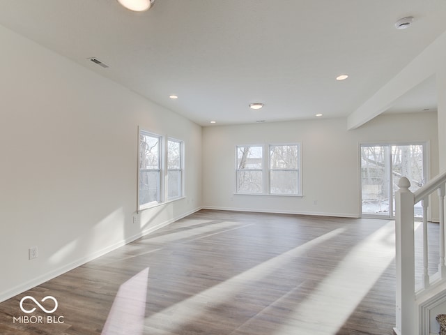 spare room featuring baseboards, visible vents, wood finished floors, and recessed lighting