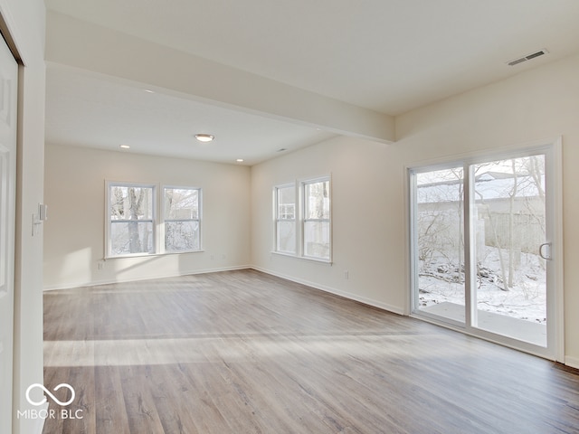 unfurnished room featuring baseboards, recessed lighting, visible vents, and light wood-style floors