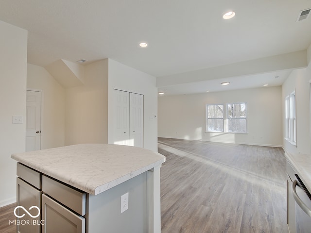 kitchen with a center island, open floor plan, light countertops, and visible vents