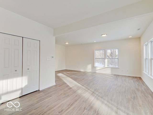 unfurnished bedroom with light wood finished floors, recessed lighting, a closet, visible vents, and baseboards