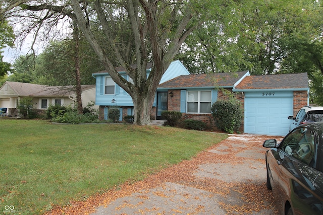 view of front of property with a front yard and a garage