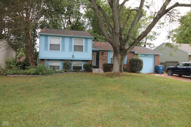 tri-level home with a front yard and a garage