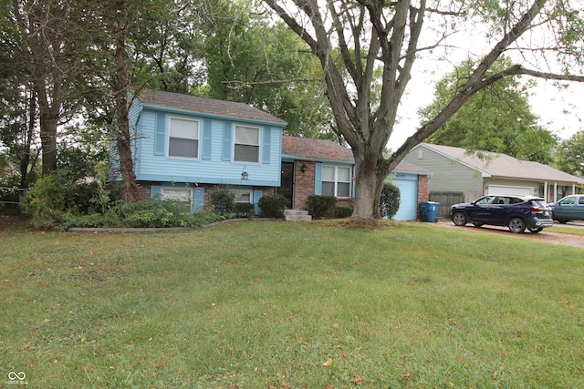 tri-level home with a garage and a front lawn