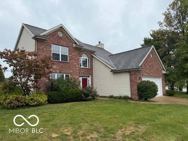 view of front of house with a front yard and a garage