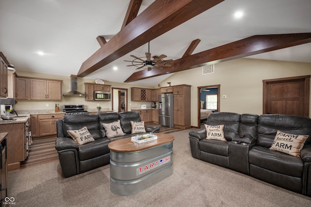 carpeted living room with vaulted ceiling with beams and ceiling fan