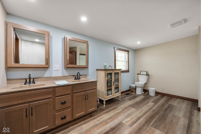 bathroom with vanity, hardwood / wood-style floors, and toilet