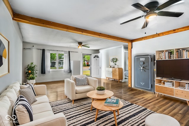 living room featuring ceiling fan, beamed ceiling, and dark hardwood / wood-style flooring