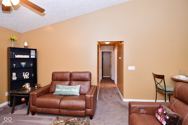 carpeted living room featuring lofted ceiling, ceiling fan, and a textured ceiling