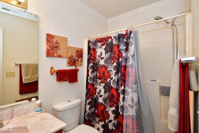 bathroom with a shower with shower curtain, vanity, and toilet