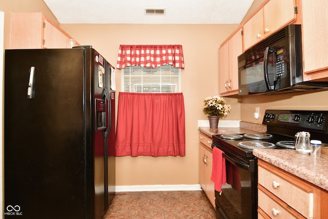 kitchen with black appliances and light brown cabinets