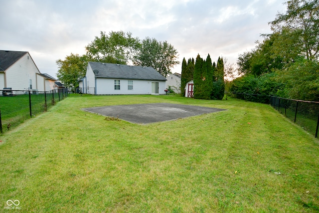 view of yard with basketball hoop