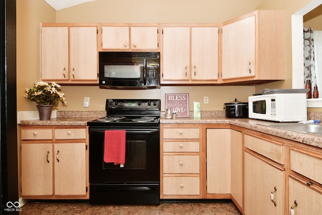 kitchen with light brown cabinetry, lofted ceiling, and black appliances