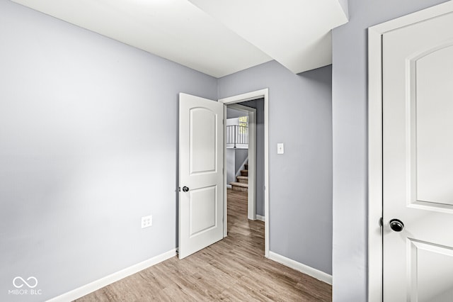 unfurnished bedroom with light wood-type flooring