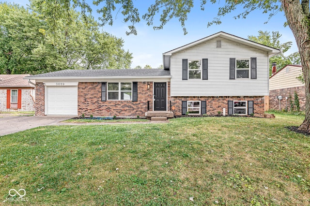 split level home with a garage and a front lawn