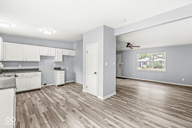 kitchen with white cabinets, light hardwood / wood-style floors, and ceiling fan