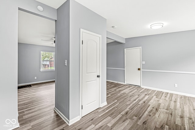 empty room featuring ceiling fan and light hardwood / wood-style flooring